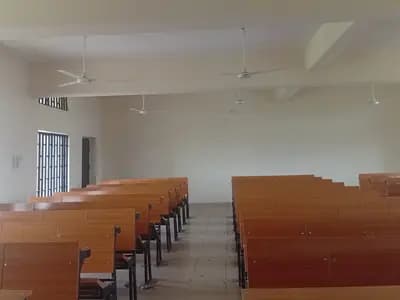 Rows of empty desks in a classroom
