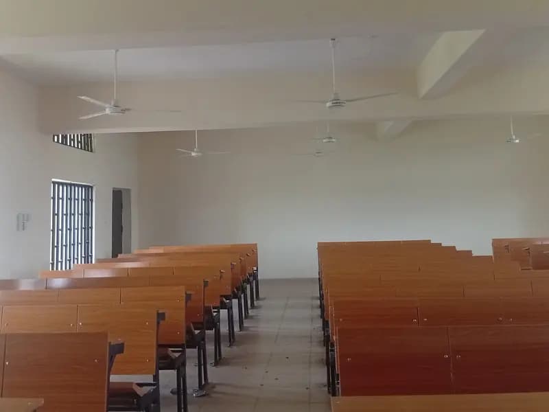 Rows of empty desks in a classroom