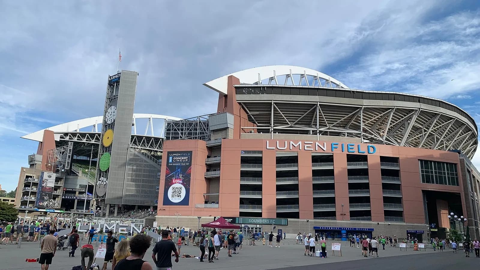 The exterior of Lumen Field in Seattle with its name above the entrance, its clock tower and curved roof, and fans gathered outside, photographed on 15 July 2023, a file photograph of the stadium and not from Sunday night's game