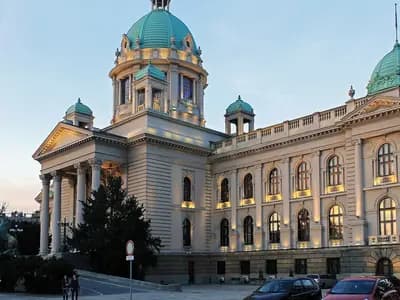 The House of the National Assembly of Serbia in Belgrade at dusk with its green copper domes and lit windows, photographed on 25 October 2015, a file photograph of the parliament building and not of this year's voting