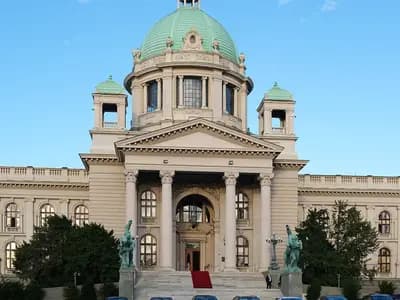 The pale stone House of the National Assembly of Serbia in Belgrade, with its green copper domes and columned portico under a blue sky, photographed on 6 November 2023, a file photograph of the parliament building and not of this week's election or its count