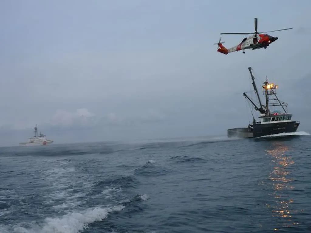 A coast guard rescue vessel at sea during a search and recovery operation, generic and unbranded