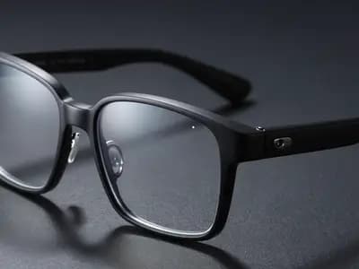 Smart glasses with a camera in the hinge on a dark surface