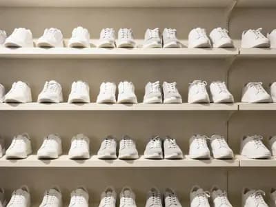 Unbranded sneakers on quiet retail shelving
