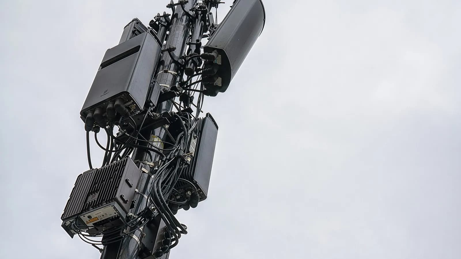 Cellular antennas and radio units clustered on a pole against an overcast sky, photographed on 18 May 2019, a file photograph illustrative of cell tower equipment and not of any site named in the report