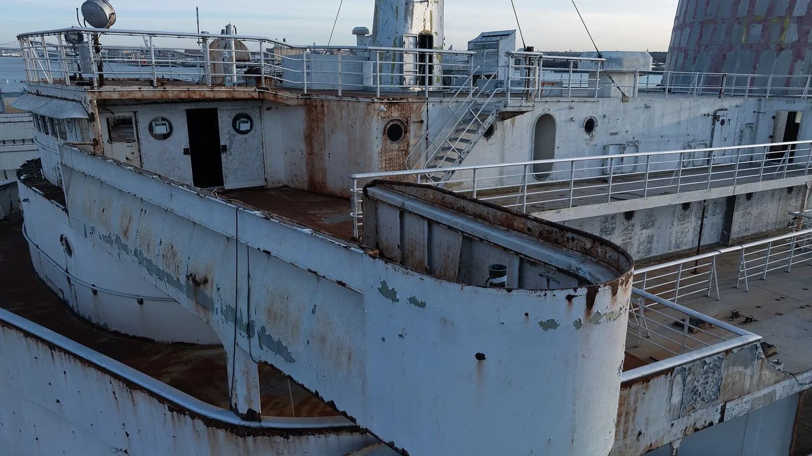 The weathered bridge wing and upper deck of the SS United States, rust-streaked white paint under open sky, photographed on 19 February 2025 on the morning she was towed out of Philadelphia, a file photograph of the ship and not of her preparation or sinking in Florida