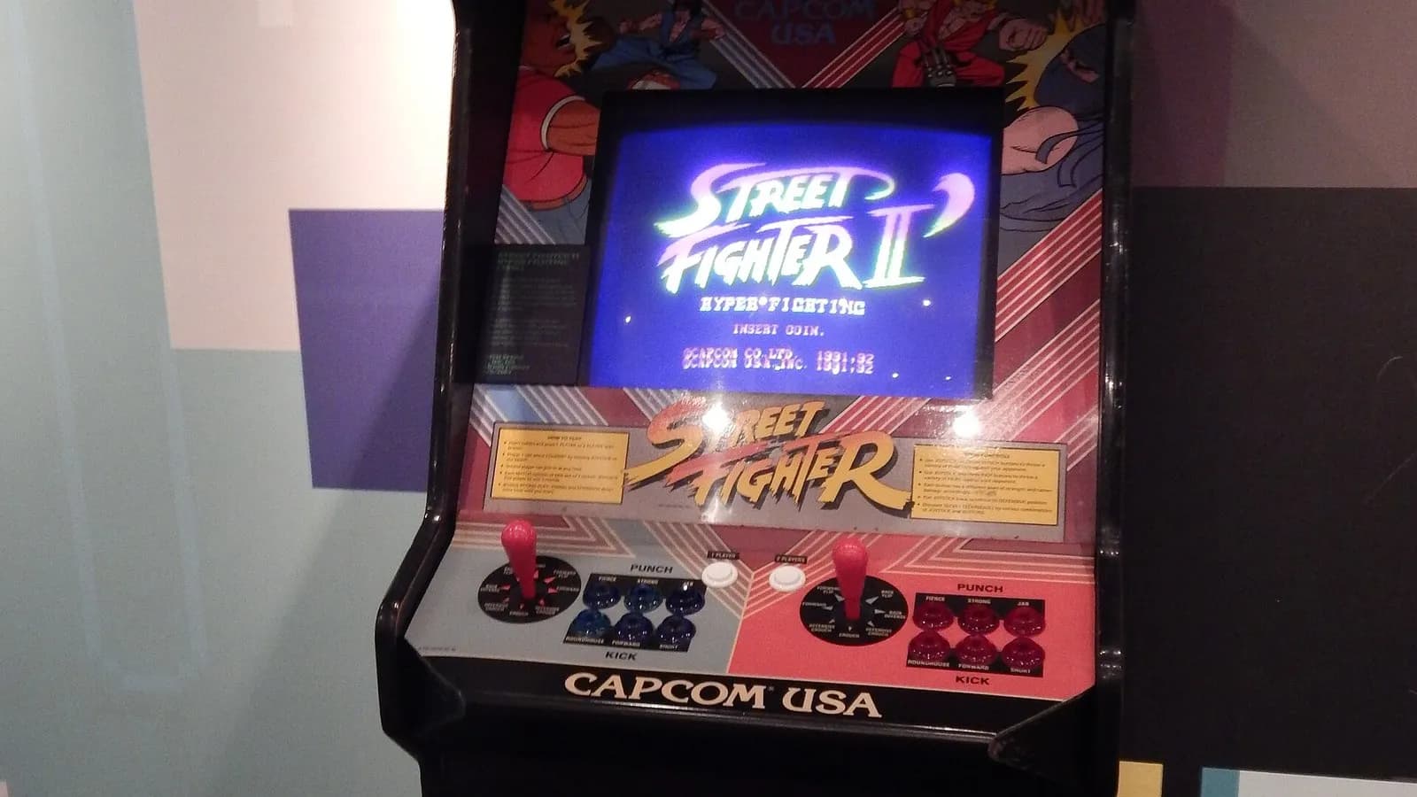 A Street Fighter II arcade cabinet from 1991 with its Capcom marquee and joysticks, on display at the Bradford Media Museum in England, photographed on 17 September 2014, a file photograph of the original game and not of the 2026 film
