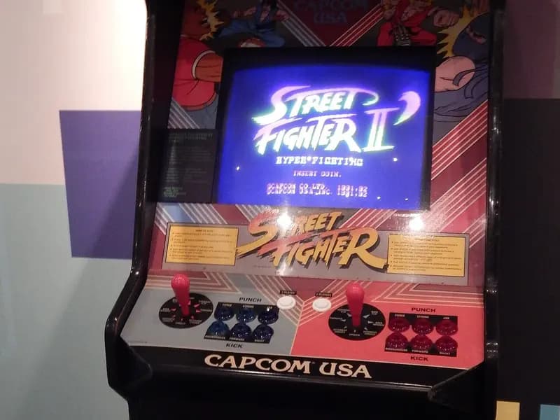 A Street Fighter II arcade cabinet from 1991 with its Capcom marquee and joysticks, on display at the Bradford Media Museum in England, photographed on 17 September 2014, a file photograph of the original game and not of the 2026 film