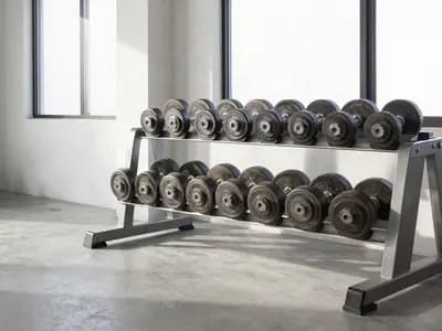 Dumbbells and a loaded barbell in a minimal gym