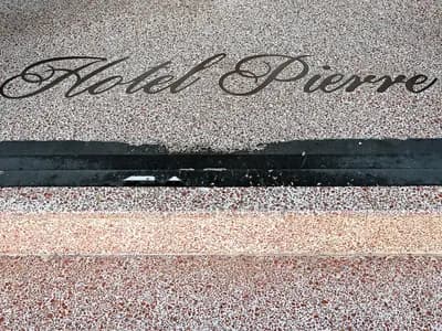 A terrazzo entrance floor with the name Hotel Pierre set into it, on Miami Beach, photographed in 2025