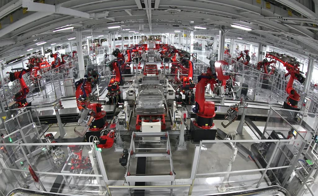 Electric vehicles moving through a highly automated factory assembly line