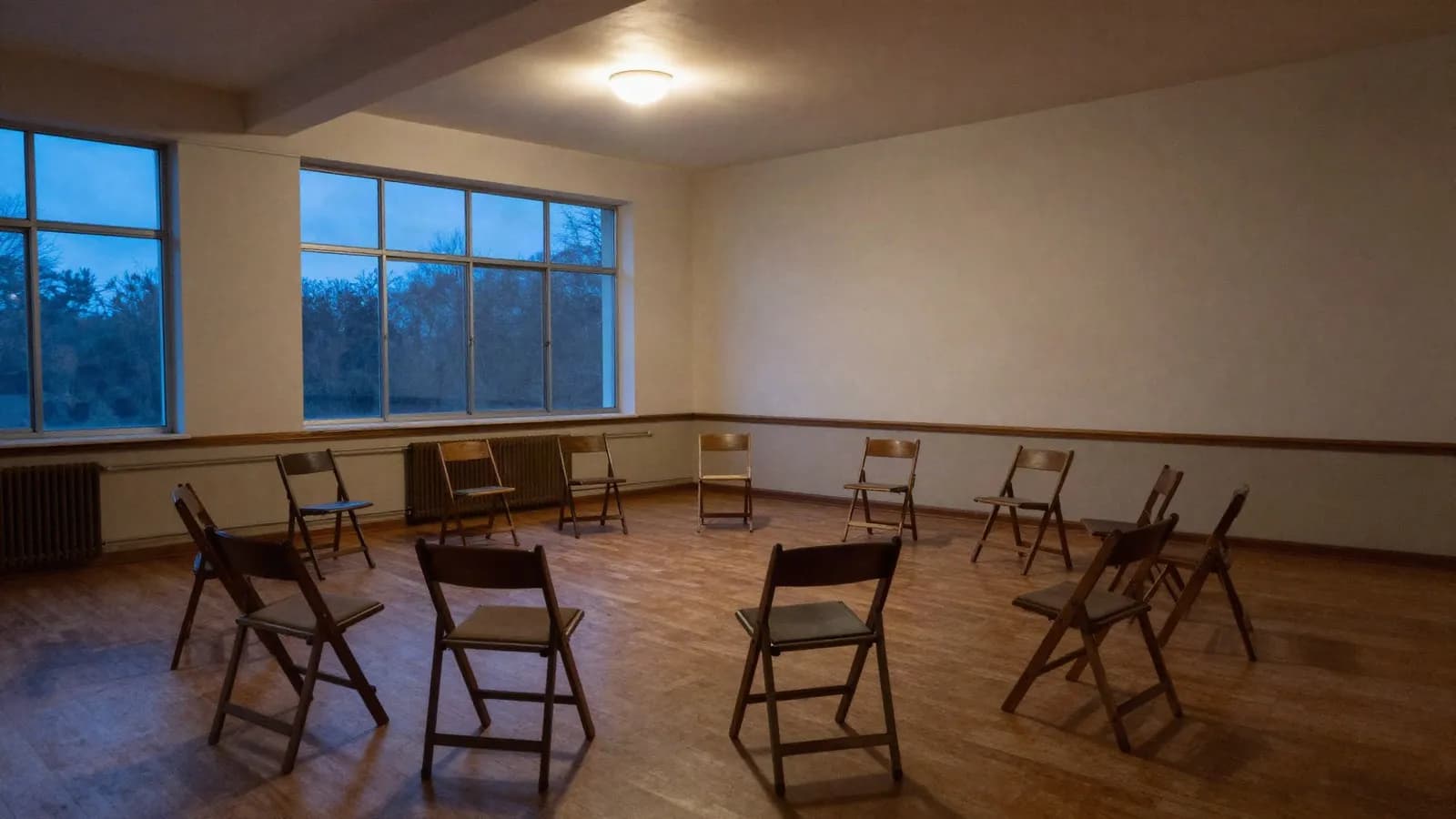 Editorial illustration of wooden folding chairs arranged in a circle in an empty community hall at dusk