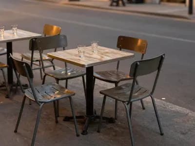Outdoor cafe tables on a quiet pavement in the evening