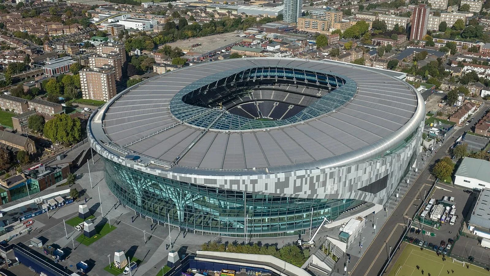An aerial view of the Tottenham Hotspur Stadium in north London with its curved roof and surrounding streets, photographed on 11 October 2022, a file photograph of the ground and not from Monday's match