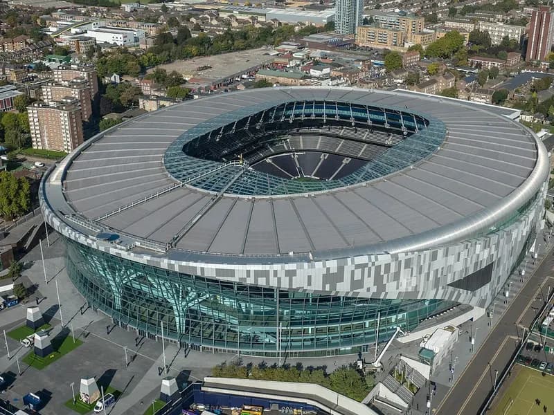 An aerial view of the Tottenham Hotspur Stadium in north London with its curved roof and surrounding streets, photographed on 11 October 2022, a file photograph of the ground and not from Monday's match