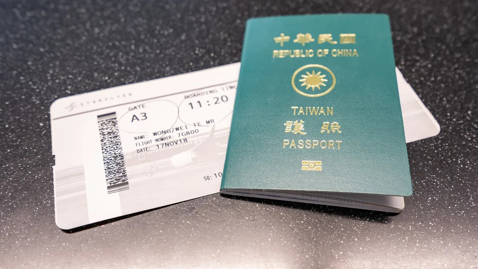 A passport and airline boarding pass laid on a table before a flight in 2018