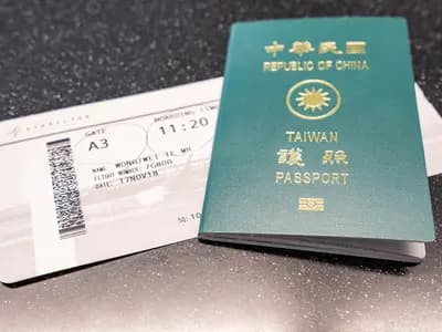 A passport and airline boarding pass laid on a table before a flight in 2018