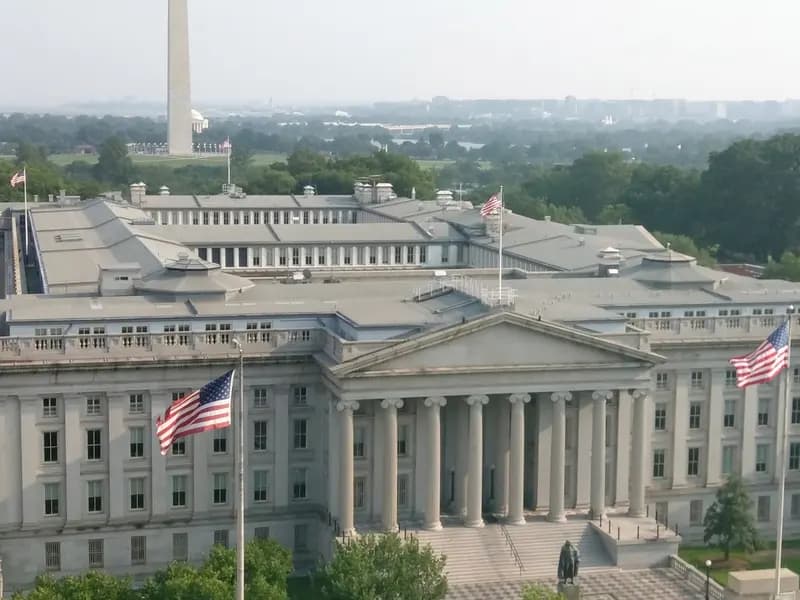 The United States Treasury building in Washington seen from above, with the Washington Monument behind