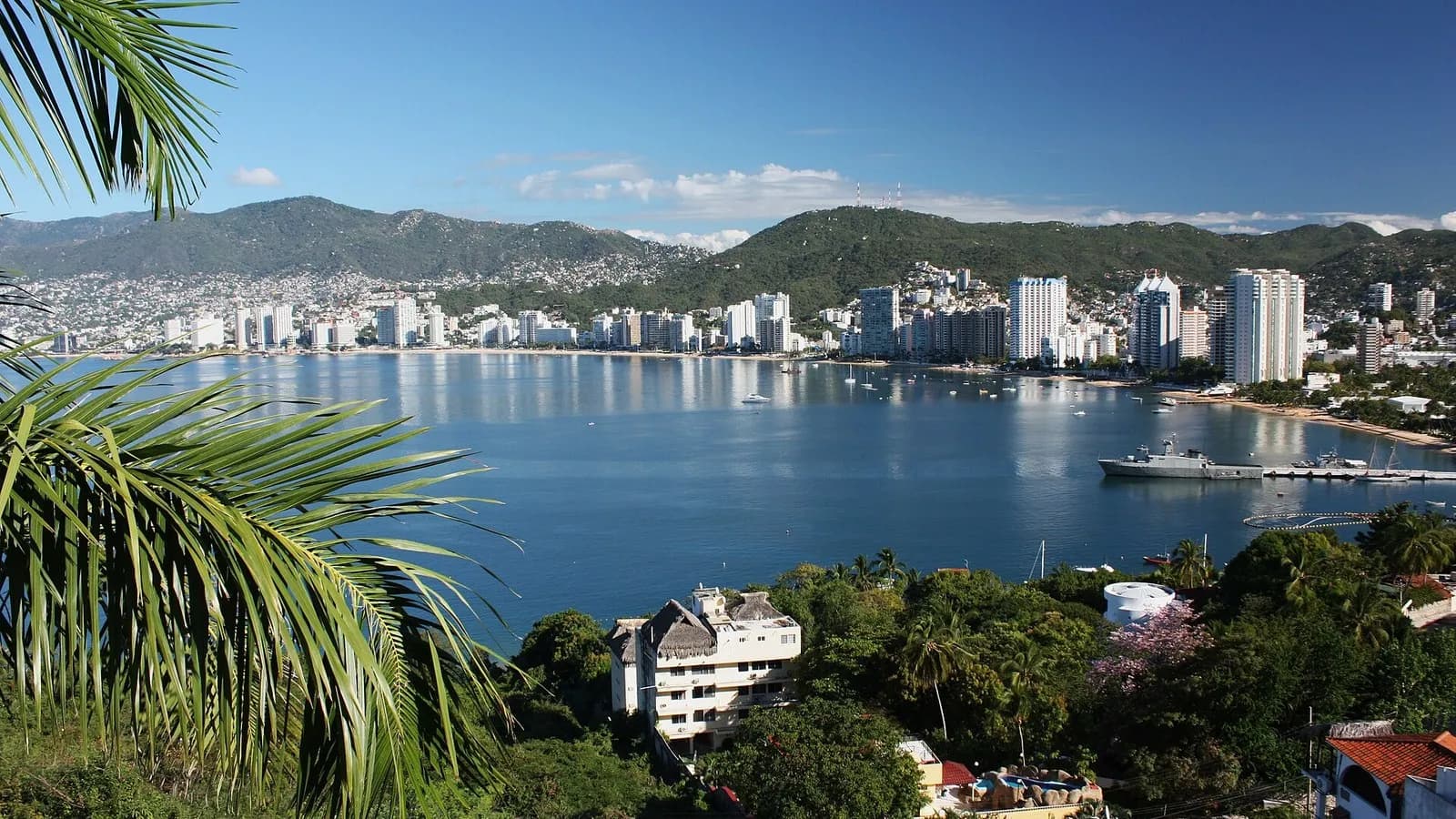 Acapulco Bay in Mexico seen from the hillside with high-rise hotels along the shore and a ship alongside a pier, photographed in February 2010, a file photograph of the bay and not of Tropical Storm Trudy