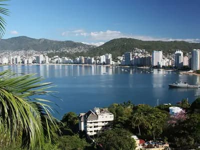 Acapulco Bay in Mexico seen from the hillside with high-rise hotels along the shore and a ship alongside a pier, photographed in February 2010, a file photograph of the bay and not of Tropical Storm Trudy