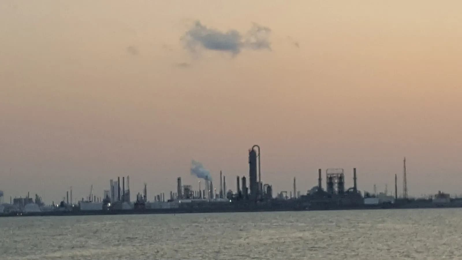A line of oil refinery stacks and flares on the Texas Gulf Coast at dusk seen across the water from the Texas City Dike, photographed on 20 May 2016, a file photograph illustrative of US refining and not of any project named in the memorandum