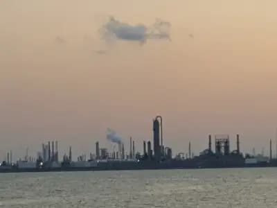 A line of oil refinery stacks and flares on the Texas Gulf Coast at dusk seen across the water from the Texas City Dike, photographed on 20 May 2016, a file photograph illustrative of US refining and not of any project named in the memorandum