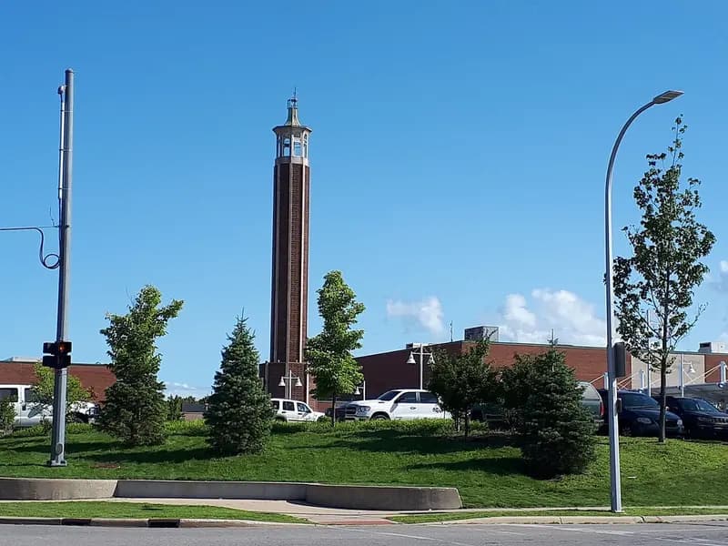 The brick tower at the McMorran Place complex in Port Huron, Michigan, rising above a lawn and car park under a blue sky, photographed on 23 August 2019, a file photograph of the venue and not of Sunday's rally