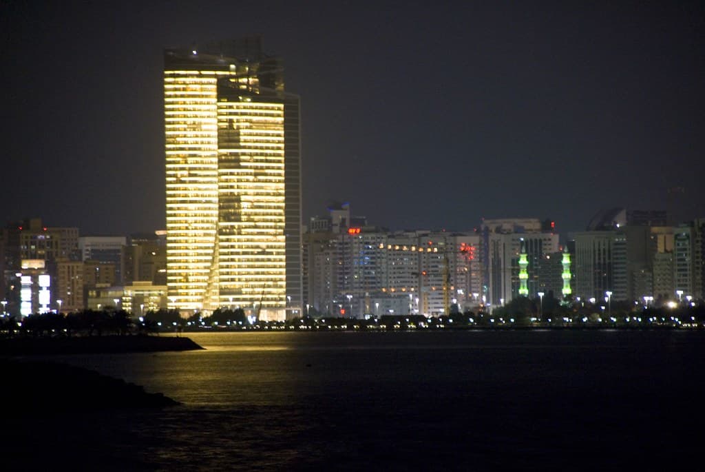 Financial screens overlooking the modern business district in the UAE