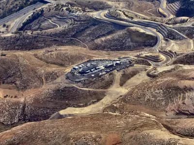 The E1 area east of Jerusalem seen from the air, with the Ma'ale Adumim interchange and the police headquarters built on the site, and bare hills around them