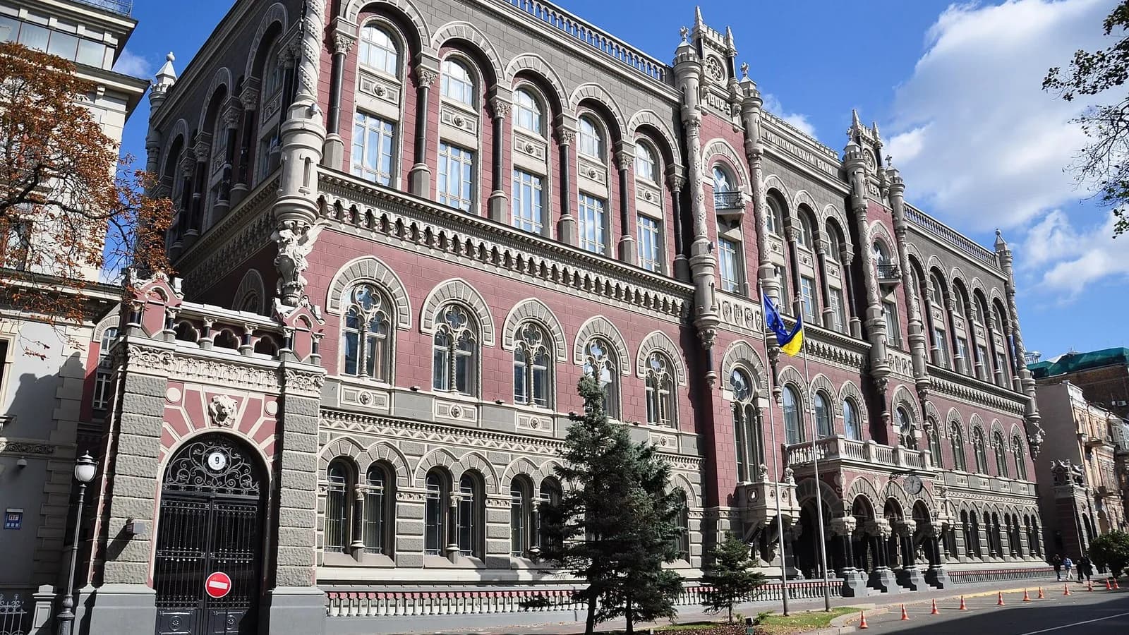 The red-brick facade of the National Bank of Ukraine building on Instytutska Street in Kyiv with Ukrainian flags and the entrance gate, photographed on 6 April 2008, a file photograph of the building and not of this week's searches