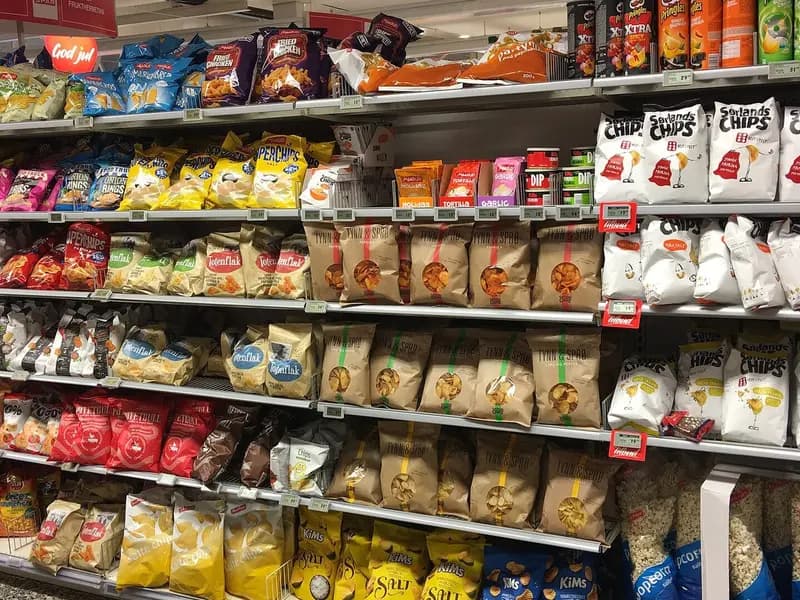 Shelves of packaged crisps and other snacks in an aisle of a supermarket in Tjome, Norway, photographed on 5 December 2017, a file photograph illustrative of packaged snack foods and not of the study participants