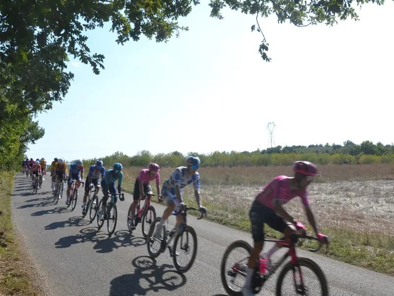 The chasing group strung out along a road on stage two of the 2026 Vuelta a Espana, between Esparron-de-Verdon and Greoux-les-Bains
