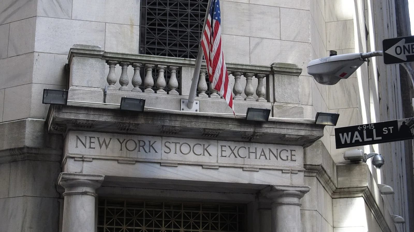 The entrance of the New York Stock Exchange on Wall Street with an American flag and street signs, photographed on 17 May 2012, a file photograph and not from Monday's trading