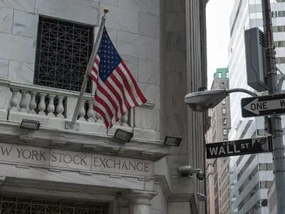 The balcony and carved lettering of the New York Stock Exchange at 11 Wall Street with an American flag, a No Entry sign for Wall Street at right and office towers behind, photographed on 19 August 2015, a file photograph of the exchange building and not of Thursday's trading