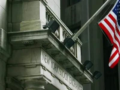 A corner of the New York Stock Exchange's stone facade with its engraved name and a United States flag on a pole above it, photographed on 10 July 2010, a file photograph of the exchange building and not of Tuesday's trading