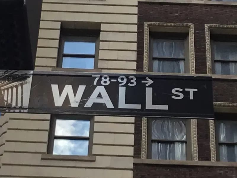 A black and white Wall Street street sign mounted on a building corner in lower Manhattan, photographed on 19 April 2022, a file photograph illustrative of the financial district and not of Friday's trading