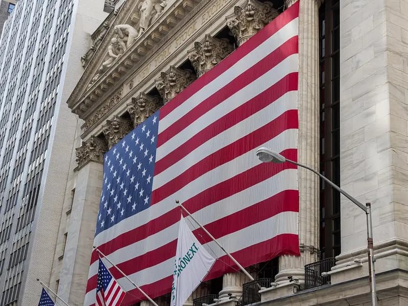 The facade of the New York Stock Exchange on Wall Street in New York City with a large American flag, photographed in July 2012, a file photograph and not from Monday's trading