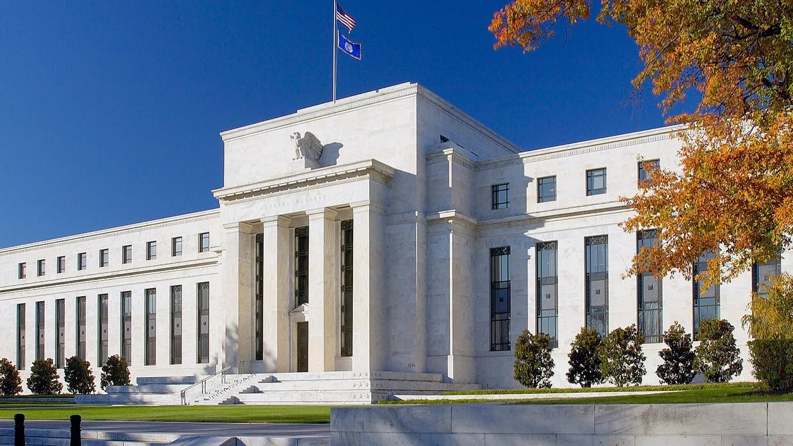 The white marble Marriner S. Eccles Federal Reserve Board Building in Washington with a flag above its portico and autumn leaves beside it, photographed on 1 September 2012, a file photograph of the central bank's headquarters and not of this week's meeting