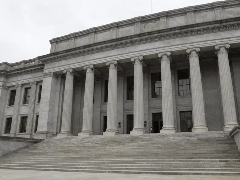The colonnaded facade of a government regulatory building