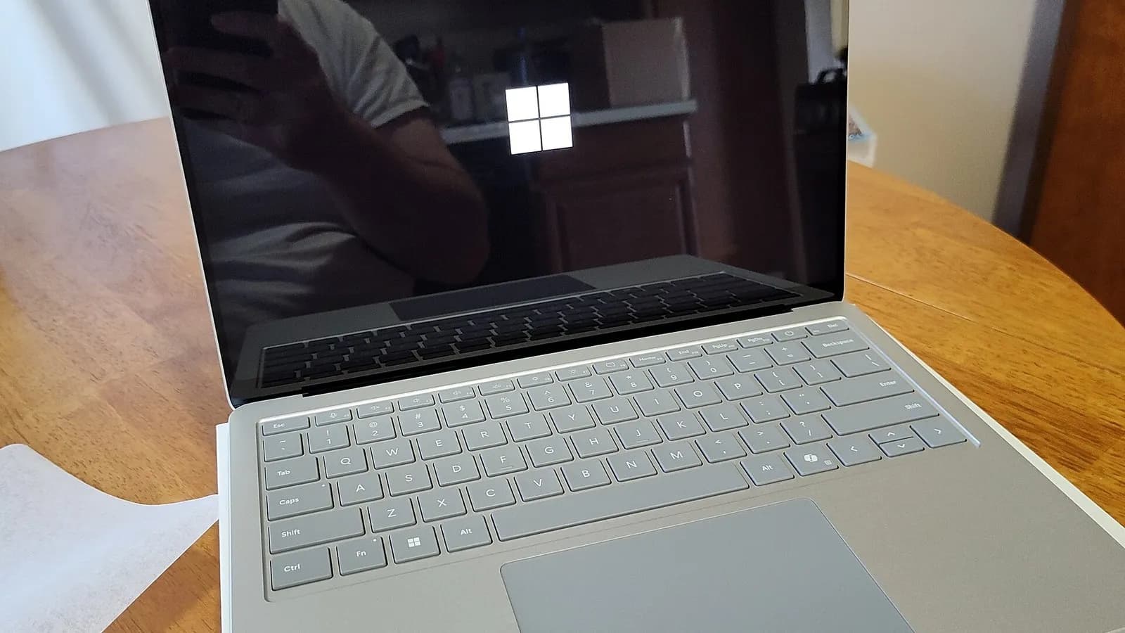 A Microsoft Surface Laptop 7 on a wooden table with the Windows logo on its screen, photographed on 11 July 2024, a file photograph illustrative of Windows 11 devices and not of the affected update