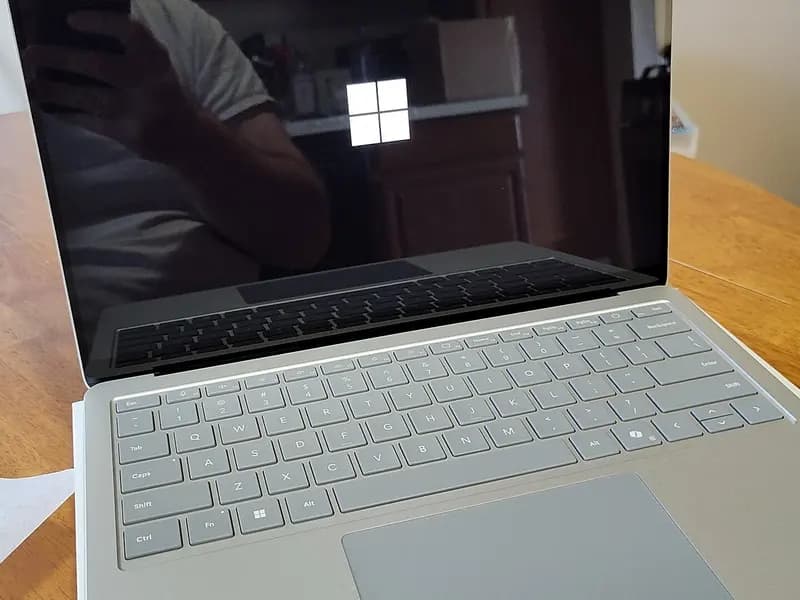 A Microsoft Surface Laptop 7 on a wooden table with the Windows logo on its screen, photographed on 11 July 2024, a file photograph illustrative of Windows 11 devices and not of the affected update