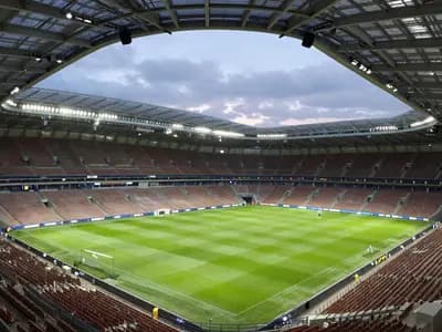 An empty modern football stadium at dusk